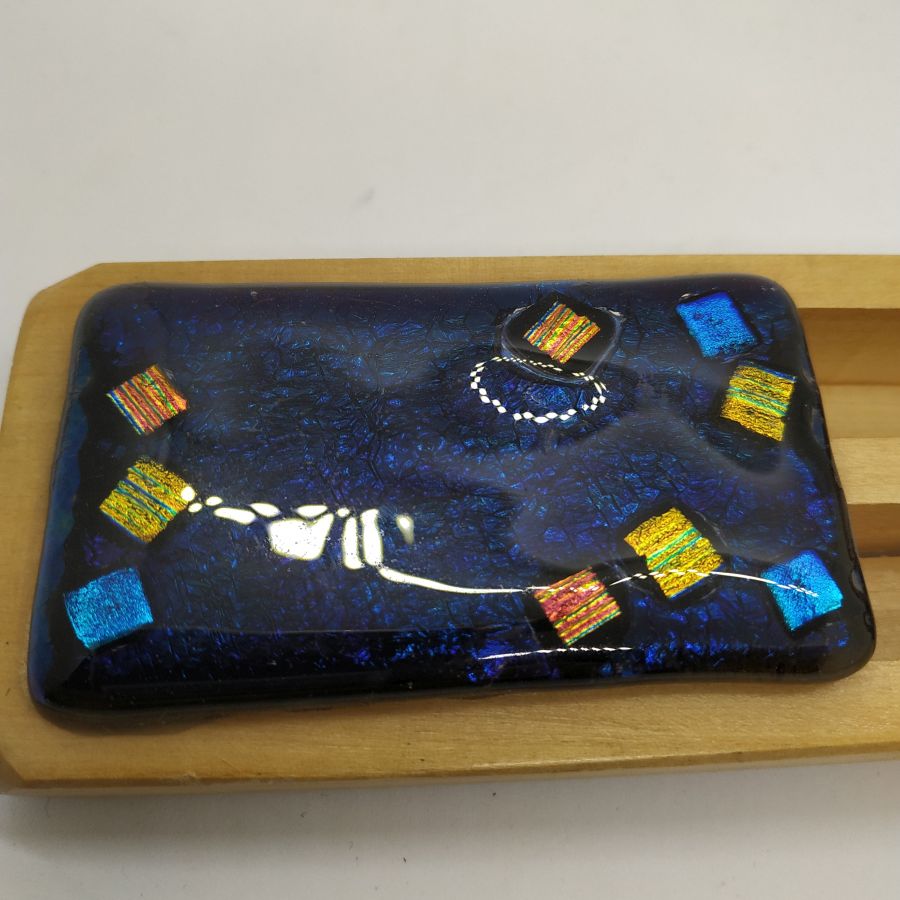 Purim Grogger fused glass and pine wood handmade multi dark colors dark blue and gold. Dimension 16 cm X 5.7 cm X 2.4 cm approximately.
