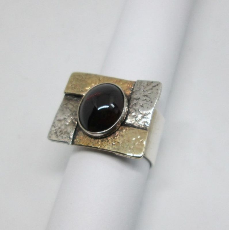 Handmade sterling silver gold Garnet ring & 14 carat gold contemporary hammered style ring set with Garnet stone & hammered silver.