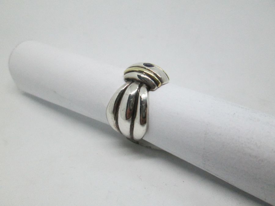 Handmade sterling silver & 14 carat gold contemporary style Amethyst gold silver ring set with Amethyst stone and tie ring shape.