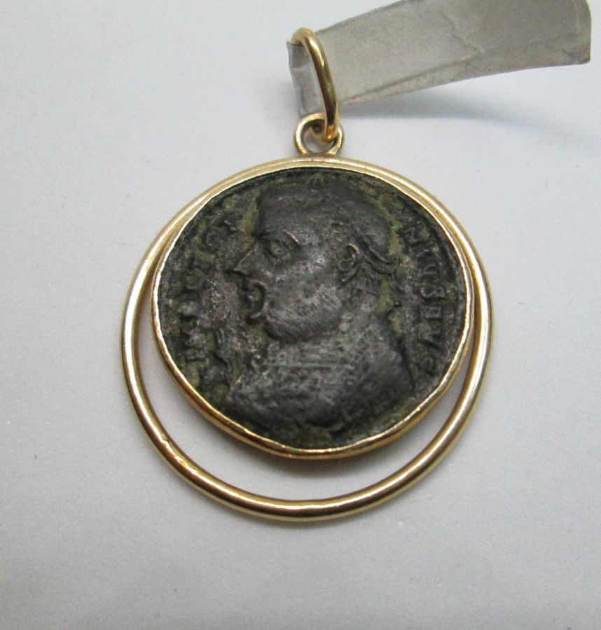 14 Carat gold antique Roman coin pendant with round wire around shape set with ancient genuine bronze Roman coin 3rd century AD.