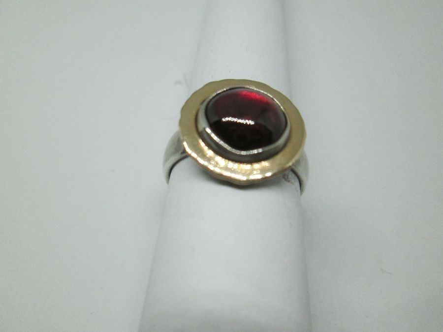 Handmade sterling silver round Garnet ring & 14 carat gold contemporary style ring set with cabochon Garnet stone.