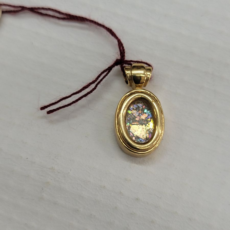 14 Carat Gold Pendant Roman Glass Oval. 14 carat gold oval pendant handmade set with ancient Roman glass. Dimension 0.9 cm X 1. 2 cm X 0.45 cm.