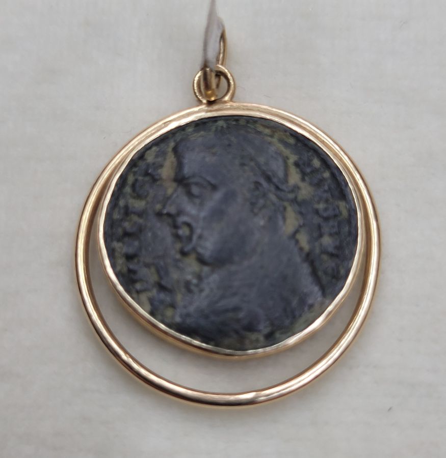 14 Carat gold antique Roman coin pendant with round wire around shape set with ancient genuine bronze Roman coin 3rd century AD.
