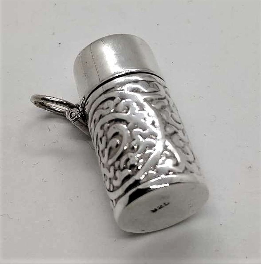 Sterling silver Mezuzah pendant container mini with open lid to insert in your private parchment with designs embossed all around it.