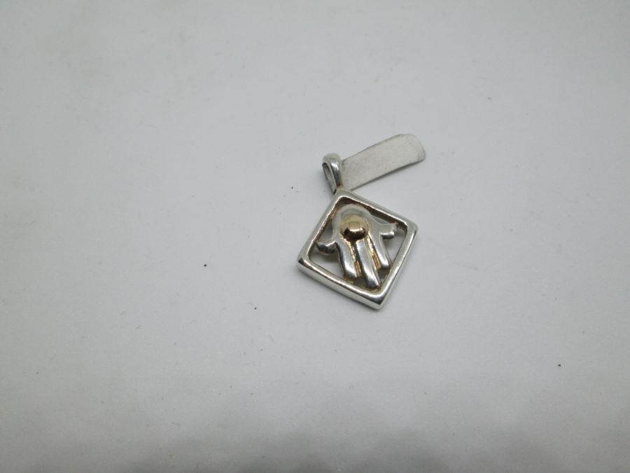 Handmade sterling silver Hamsa Chamsa pendant framed set with 14 carat gold dot and with square frame. Dimension 1.85 cm X 1.85 cm X 0.45 cm approximately.