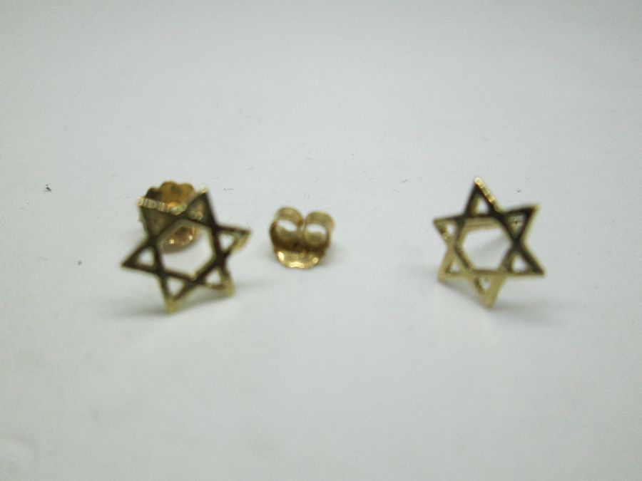 Handmade 14 carat gold Magen David stud earrings cut out miniature size star of David design . Dimension 0.7 cm X 0.8 cm approximately.