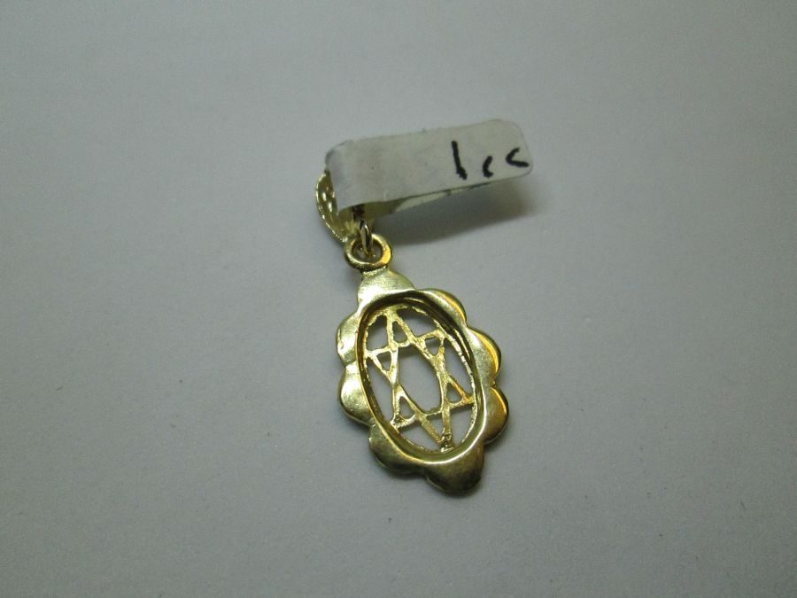 Handmade 14 carat yellow gold oval shape Magen David star pendant enameled blue white colors of Israel flag 1.2 cm X 1.8 cm X 0.1 cm.