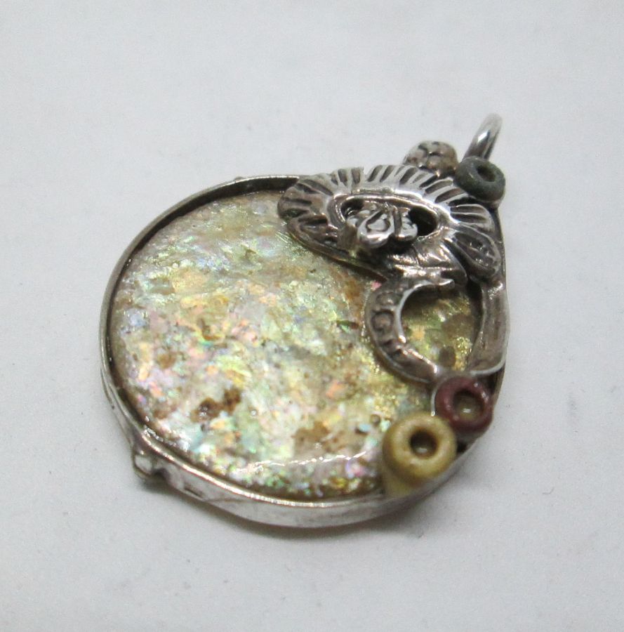 Handmade sterling silver Roman glass pendant flowers on top set with genuine Roman glass . Dimension 2.5 cm X 3.2 cm approximately.