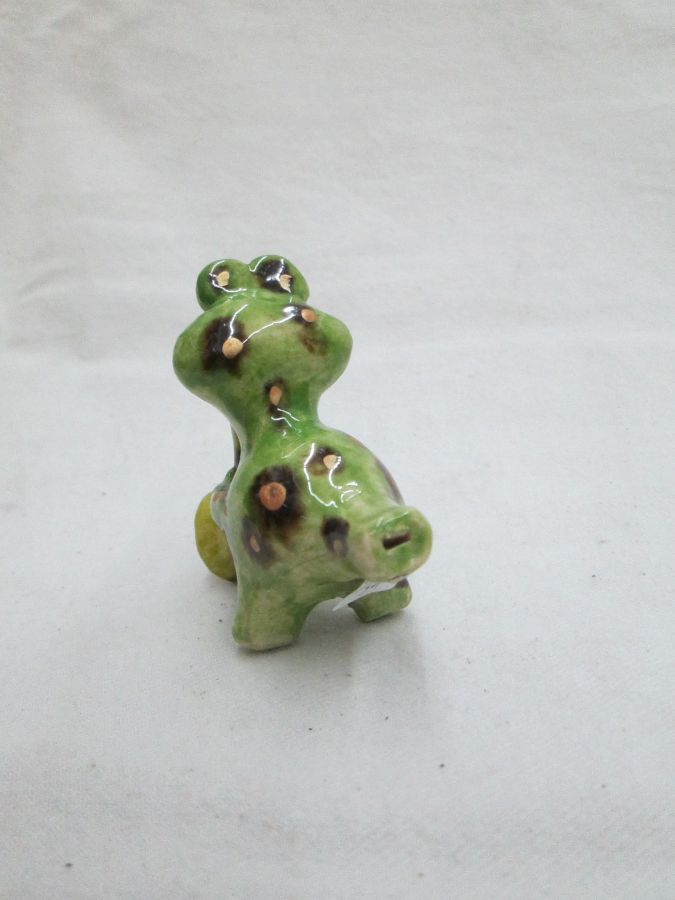 Handmade glazed ceramic frog playing jazz, it is also a whistle made by T. Labok. Dimension 6.8 cm X 6.1 cm X 3.3 cm approximately.