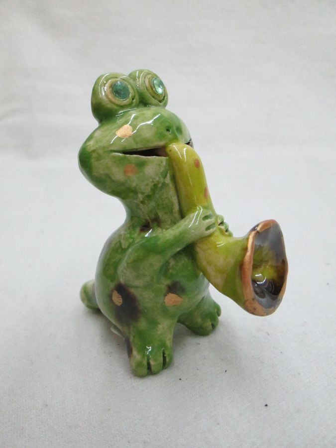 Handmade glazed ceramic frog playing jazz, it is also a whistle made by T. Labok. Dimension 6.8 cm X 6.1 cm X 3.3 cm approximately.