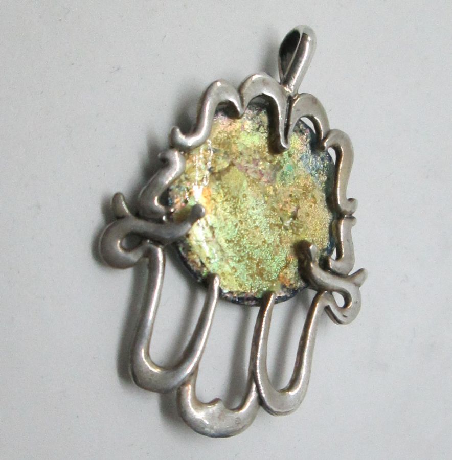 Handmade sterling silver Hamsa Roman glass Chamsa pendant set with genuine Roman glass abstract design. Dimension 2.8 cm X 3.4 cm approximately.