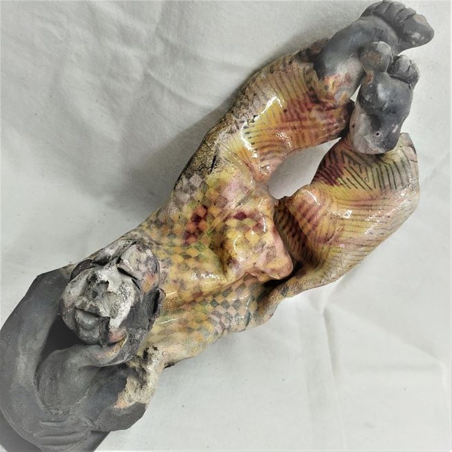 S. Factor has made this beautiful glazed ceramic sculpture in Roku ceramic a shabby clown resting, enjoying the sun, 25 cm X 15.8 cm X 23 cm.