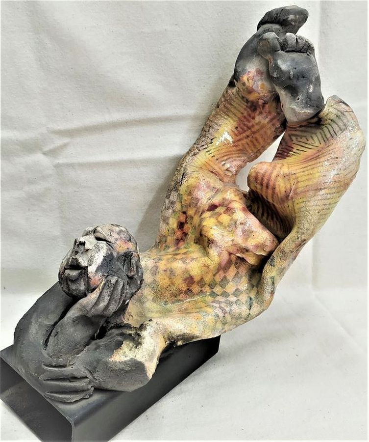 S. Factor has made this beautiful glazed ceramic sculpture in Roku ceramic a shabby clown resting, enjoying the sun, 25 cm X 15.8 cm X 23 cm.
