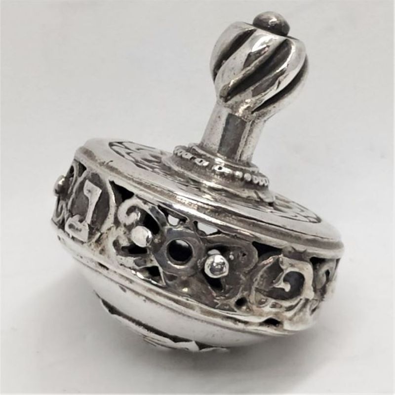 Dreidel Foliage Carved Silver handmade. Handmade sterling silver dreidel foliage carved sterling silver. Dimension diameter 2.9 cm X 3.5 cm.