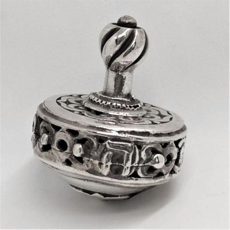 Dreidel Foliage Carved Silver handmade. Handmade sterling silver dreidel foliage carved sterling silver. Dimension diameter 2.9 cm X 3.5 cm.