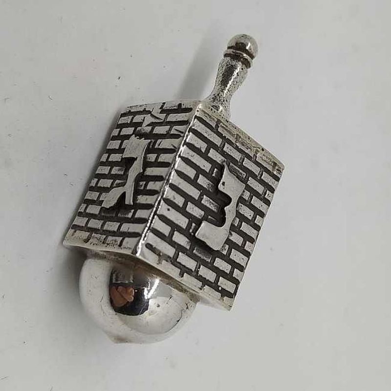 Hanukah Dreidel Silver Kotel Stones. Handmade sterling silver dreidel Kotel design . Dimension 1.8 cm X 1.8 X 4.1 cm approximately.