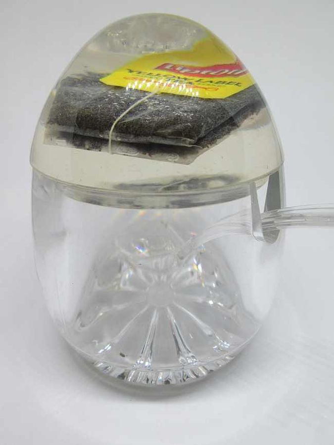 RoshHashana honey dish Perspex with a sugar cube and tea bag in Perspex cover. Dimension diameter 8.8 cm X 11.2 cm approximately.