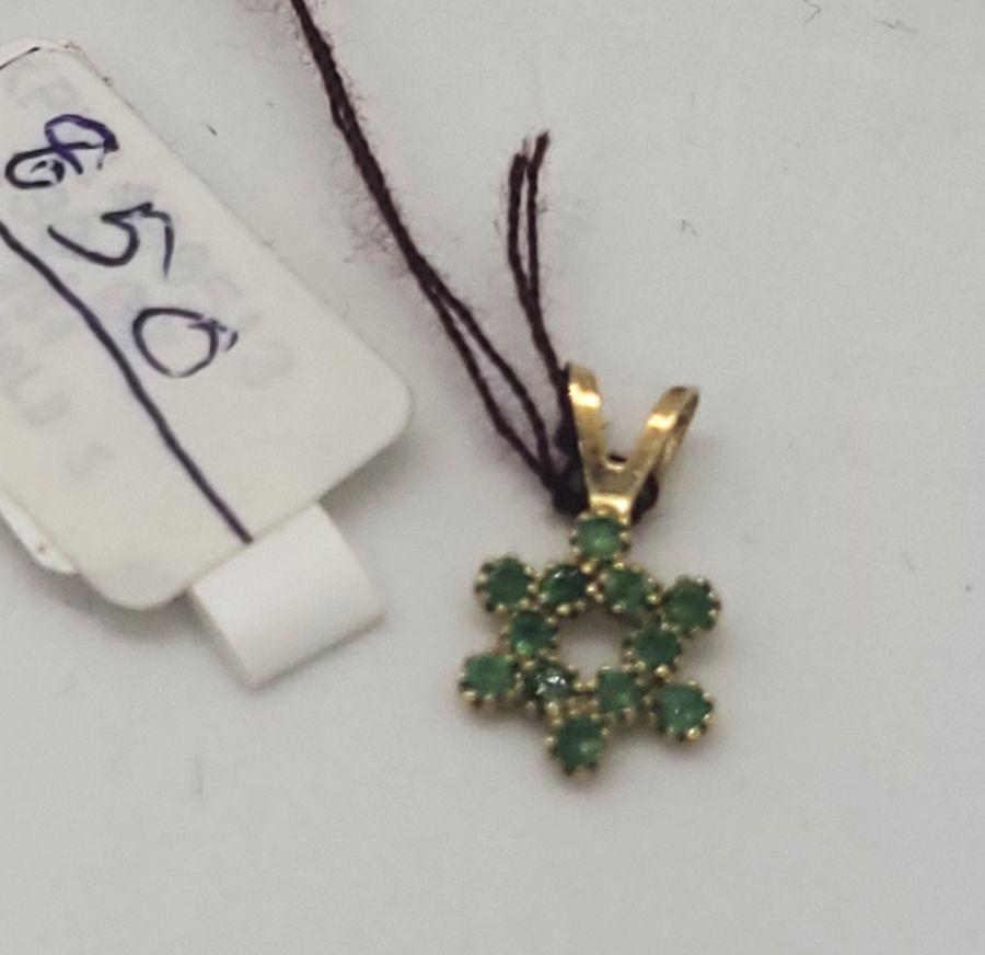 Handmade 14 carat gold 12 Emeralds Magen David star pendant set in and forming a star of David 1.35 cm X 0.8 cm X 0.1 cm approximately.