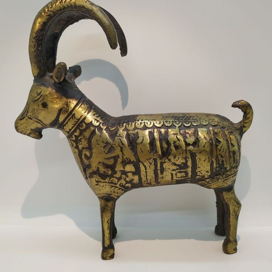 Vintage Brass Statue Antelope handmade. A vintage brass statue Antelope with big rounded horns with warriors design around animal body.