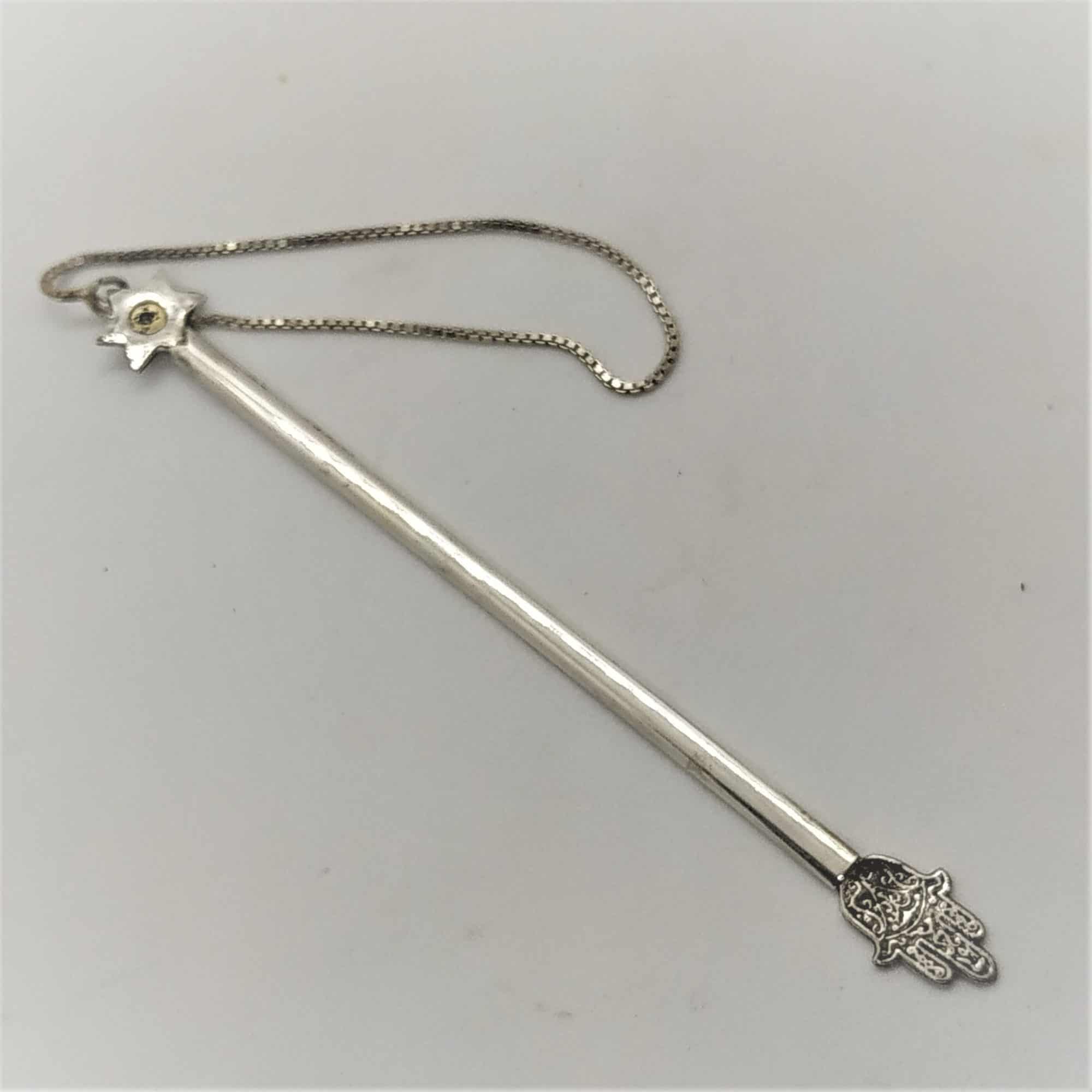 Silver Gold Torah Pointer handmade by Samy Ghatan Katan and set with a garnet stone . Dimension 12.8 cm X 1 cm approximately.