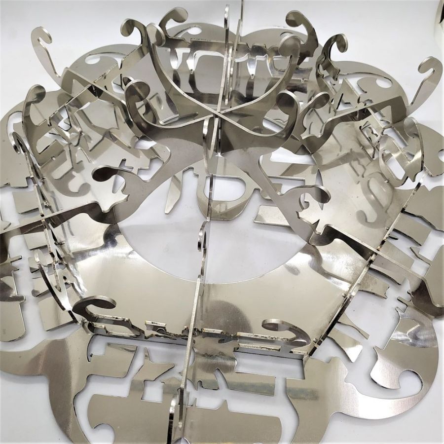 The laser cut Passover dish stainless steel design are the names of the food cut out and distinguished. Numbered & signed by artist diameter 35 cm X 15 cm.