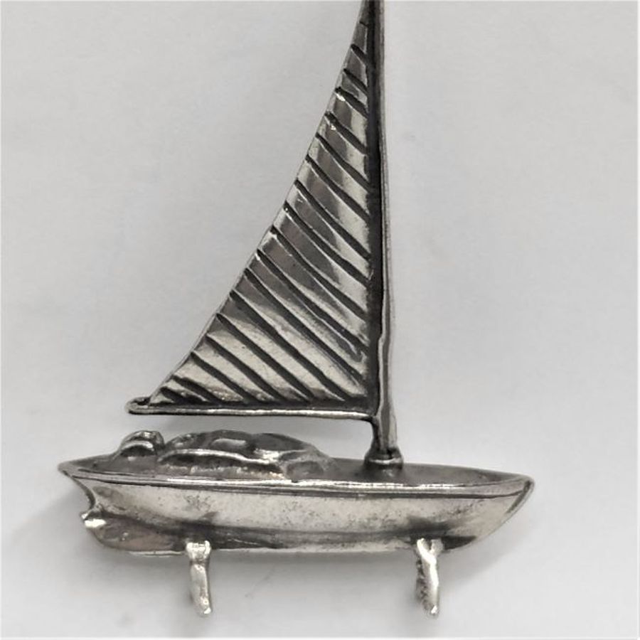 A handmade sterling silver miniature One sail boat Sculpture with one sailing pole .Dimension 4.2 cm X 1 cm X 6 cm approximately.