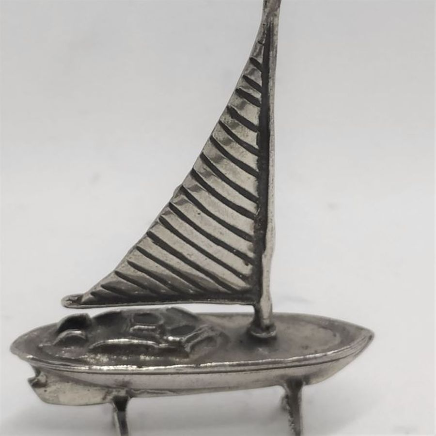 A handmade sterling silver miniature One sail boat Sculpture with one sailing pole .Dimension 4.2 cm X 1 cm X 6 cm approximately.
