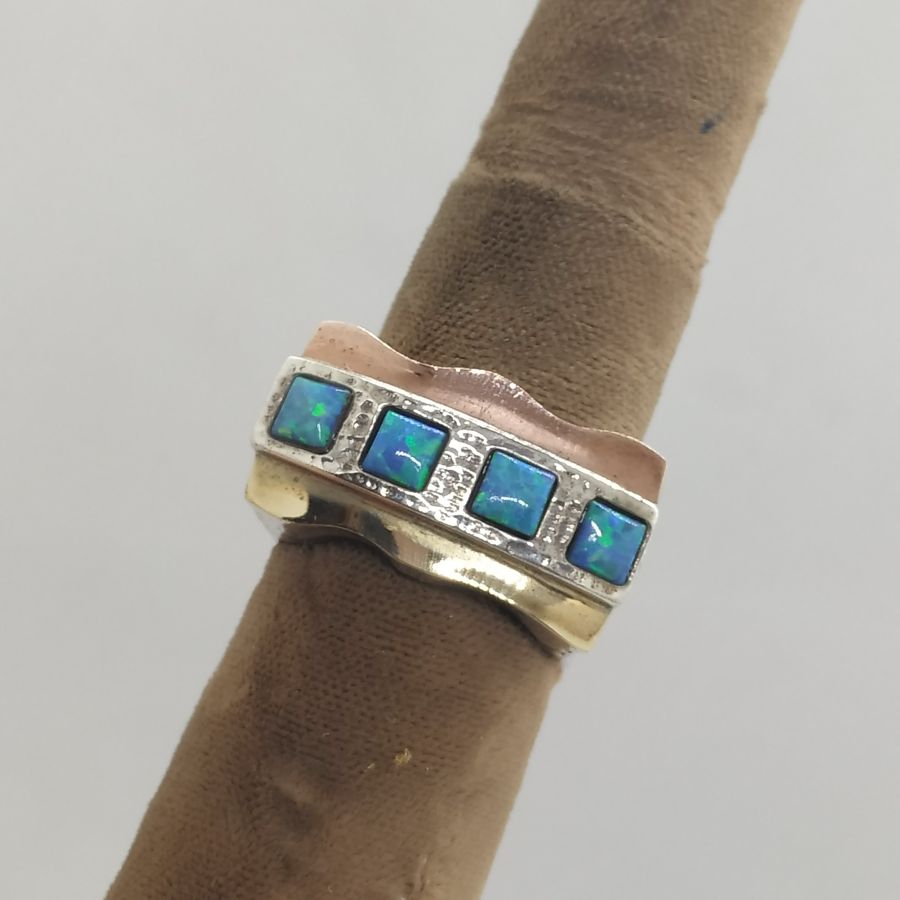 Handmade sterling silver and 14 carat yellow and rose gold Opal ring gold silver . It is set with four square opal stones 2.5 cm X 2.4 cm.