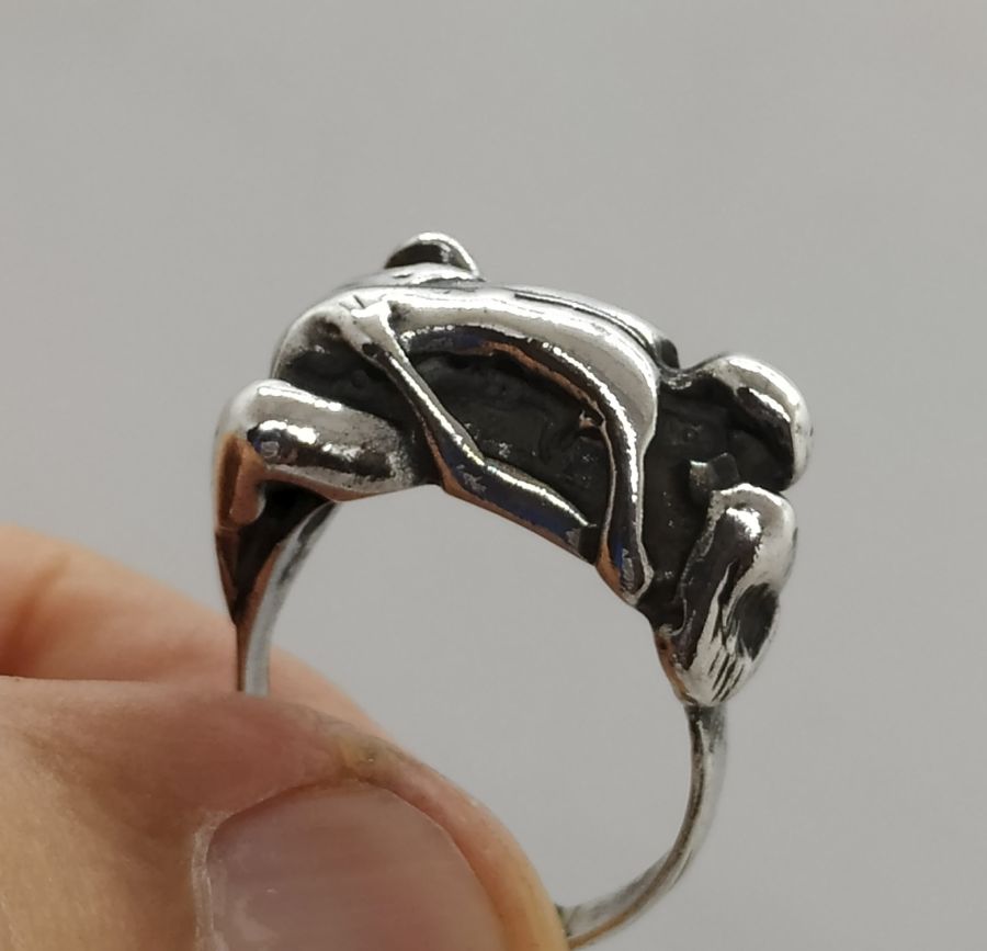 A man & woman making love couple making love ring is solid heavy silver . The finger USA size is 7.5, European finger size 55.
