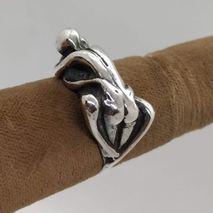 A man & woman making love couple making love ring is solid heavy silver . The finger USA size is 7.5, European finger size 55.