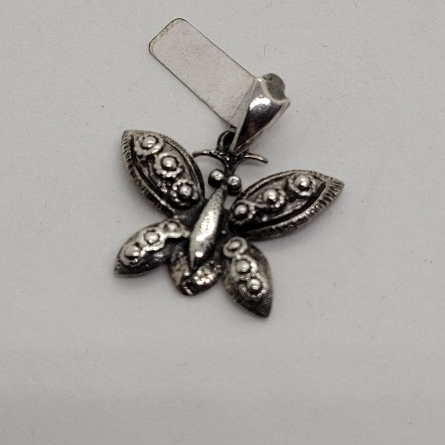 Handmade butterfly sterling silver pendant three dimension forming a butterfly. Dimension butterfly 2.3 cm X 2.3 cm X 0.3 cm approximately.