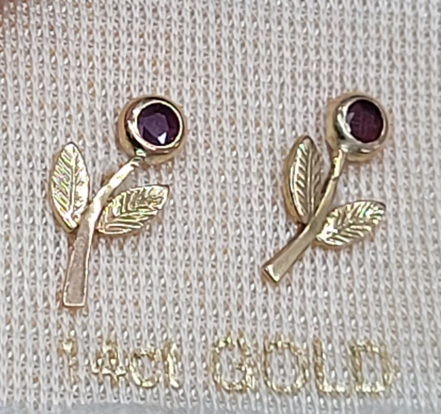 Handmade 14 carat gold flower stud earrings set with genuine faceted two Rubies. Dimension 1 cm X 1.2 cm approximately.