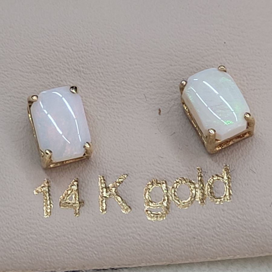 Handmade 14 carat gold cabochon Opal stud earrings set with two cabochon fire Opal stones handmade. Dimension 0.5 cm X 0.7 cm approximately.