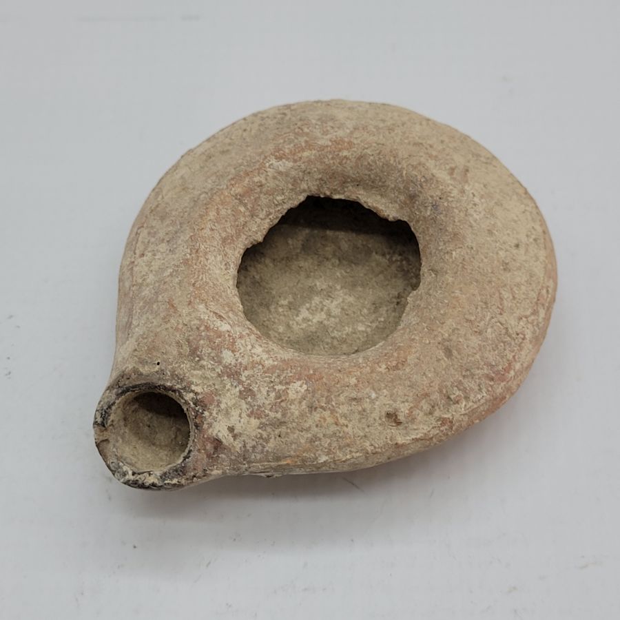 Antique round Herodian oil lamp 1st century, early King Herod era found in the Holy Land of Israel 1st century CE. Dimension 8.5 cm X 7 cm X 2 cm.