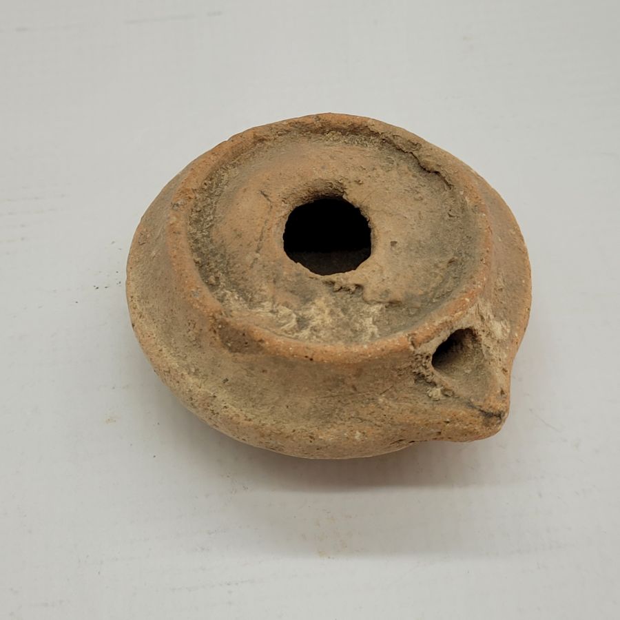 Genuine antique round Roman oil lamp early Roman era. It is from private collection. Dimension 7.5 cm X 15 cm X 7 cm approximately.