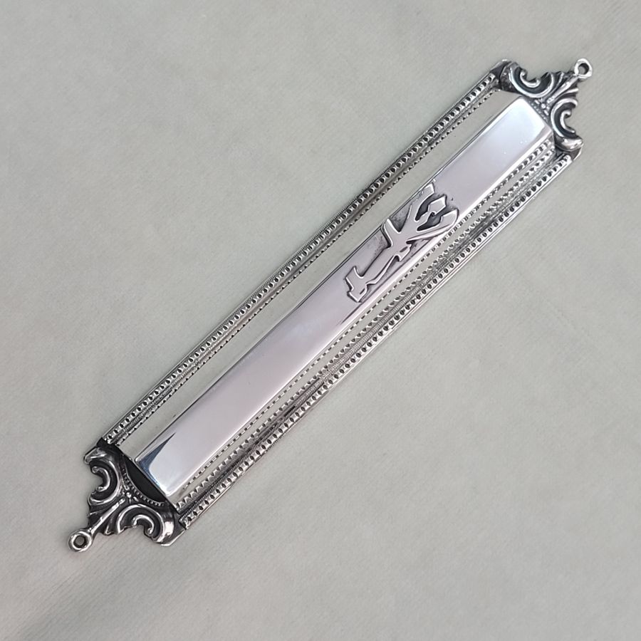 Handmade sterling silver Mezuzah trapeze shape with carvings on top and bottom of Mezuzah. Dimension 1.5 cm X 15 cm X 3 cm approximately.