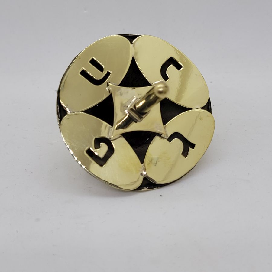 An original and one of a kind Brass Dreidel Sevivon contemporary design made by S. Ghatan Katan from Jerusalem diameter 5.8 cm X 6.9 cm approximately.