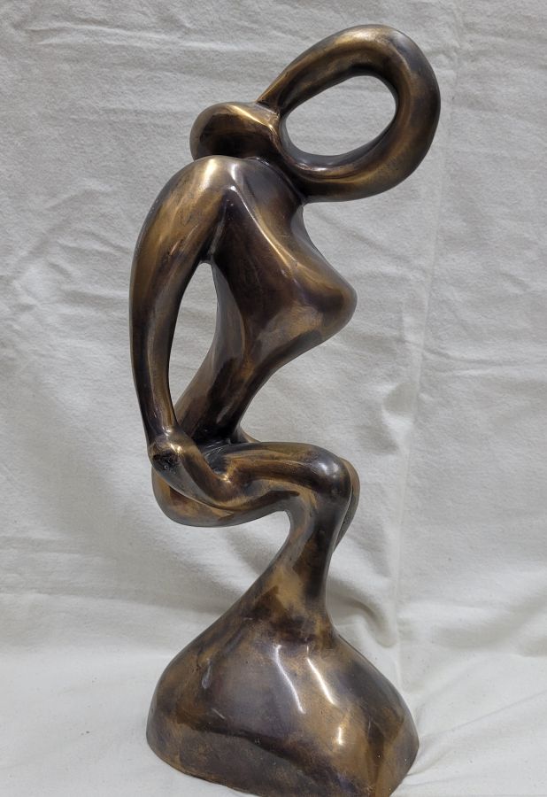 Handmade bronze sculpture lady exercising her muscles, described by artist in a fabulous abstract contemporarily design 37 cm X 14 cm X 11 cm approximately.