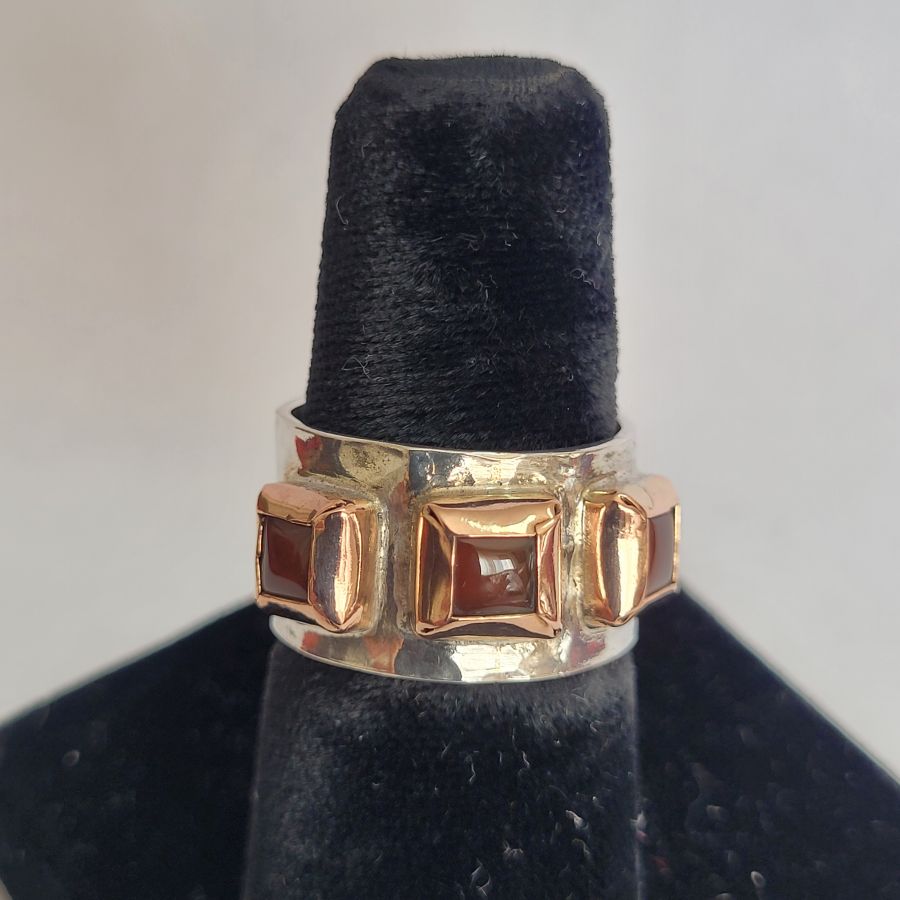 Handmade 14 carat gold and sterling silver gold Garnet ring contemporary style ring set with 3 Garnet stones and hand hammered silver.