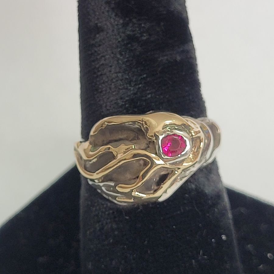 Original abstract genuine Ruby ring made with sterling silver and 14 carat gold and set with genuine red Ruby stone 1.5 cm X 1.2 cm approximately.
