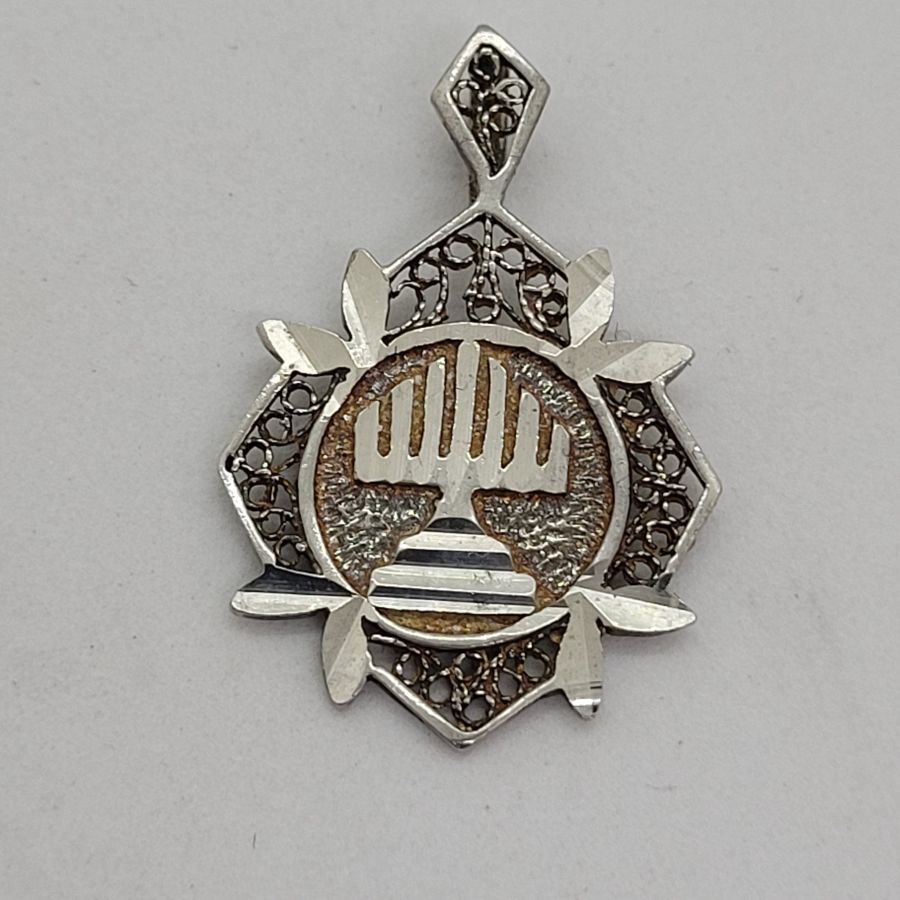 Handmade sterling silver Yemenite filigree Menorah pendant diamond shape, and diamond cut finish for a sparkling look 3.2 cm X 2.2 cm approximately.