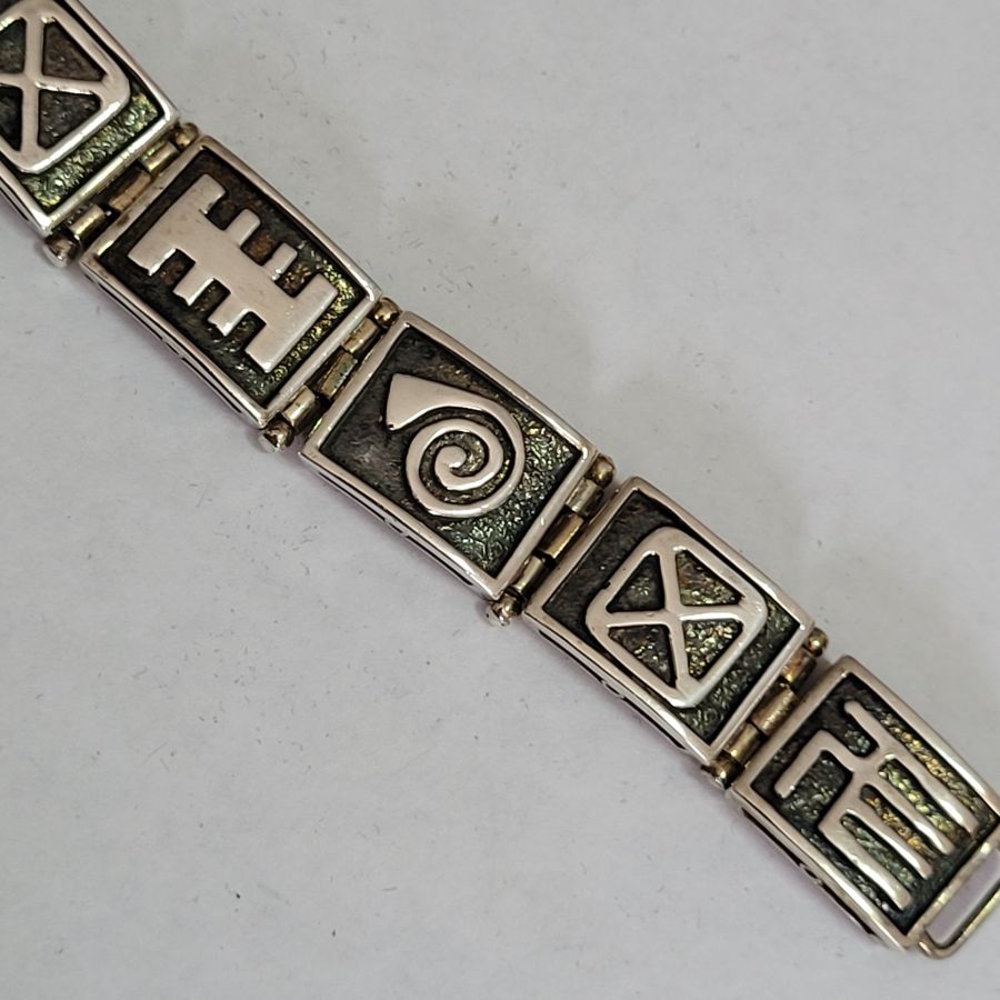 Handmade contemporary designed sterling silver abstract heavy silver bracelet solid, with unusual characteristic designs on each silver bracelet link.