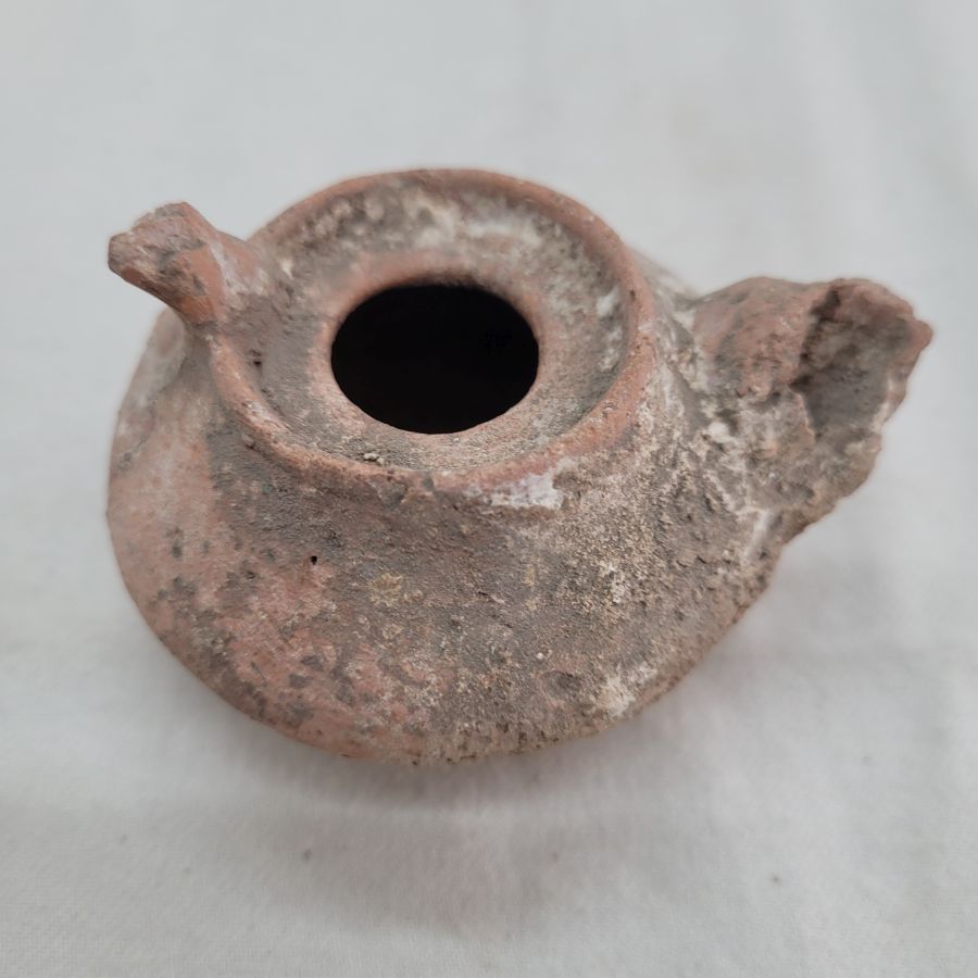 Genuine antique Roman oil lamp round Roman era in the holly land, as can be seen in photos, it has been damaged by age 7 cm X 4 cm X 6 cm.