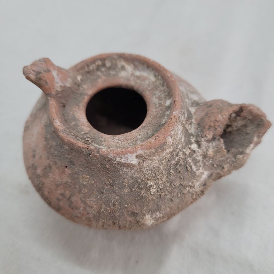 Genuine antique Roman oil lamp round Roman era in the holly land, as can be seen in photos, it has been damaged by age 7 cm X 4 cm X 6 cm.