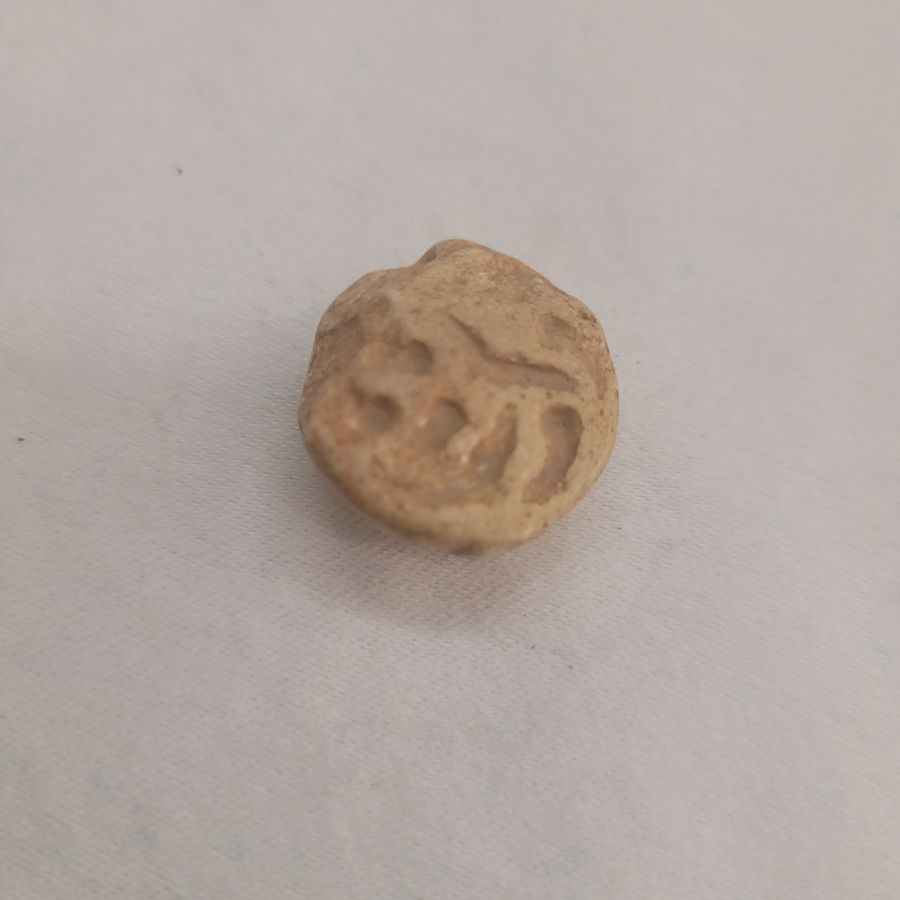 Antique pottery shard pendant made in the middle east 1st century B.C. used in the holly Jewish temple as a receipt paid for the offers given to the temple.
