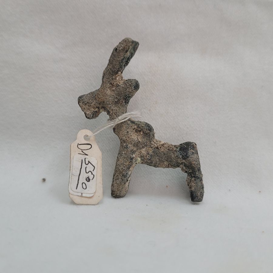 Genuine bronze deer idol antique has a loop on deer back to attach on a cord around neck but as generations of earth and corrosion, it looks like a hump.