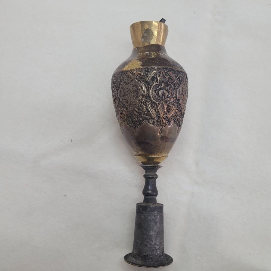 The engravings on vintage Purim Raashan Grogger brass are handmade & hammered brass showing different floral design and on top a brass bell.