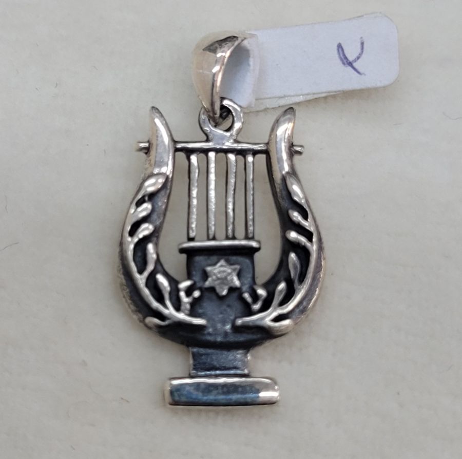 In silver David harp pendant, there is a small Magen David star in center of harp. Dimension 3 cm X 1.6 cm X 0.25 cm approximately.