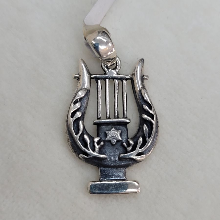 In silver David harp pendant, there is a small Magen David star in center of harp. Dimension 3 cm X 1.6 cm X 0.25 cm approximately.