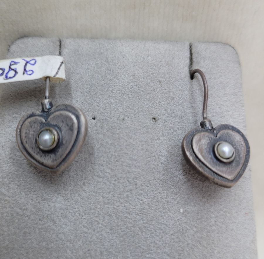 Handmade sterling silver heart shape earrings set with white round genuine pearl in center of heart. Dimension 1.6 cm X 1.2 cm approximately.